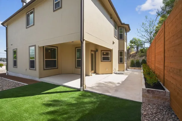 a view of a house with backyard and porch