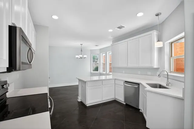 a kitchen with a sink stove and cabinets