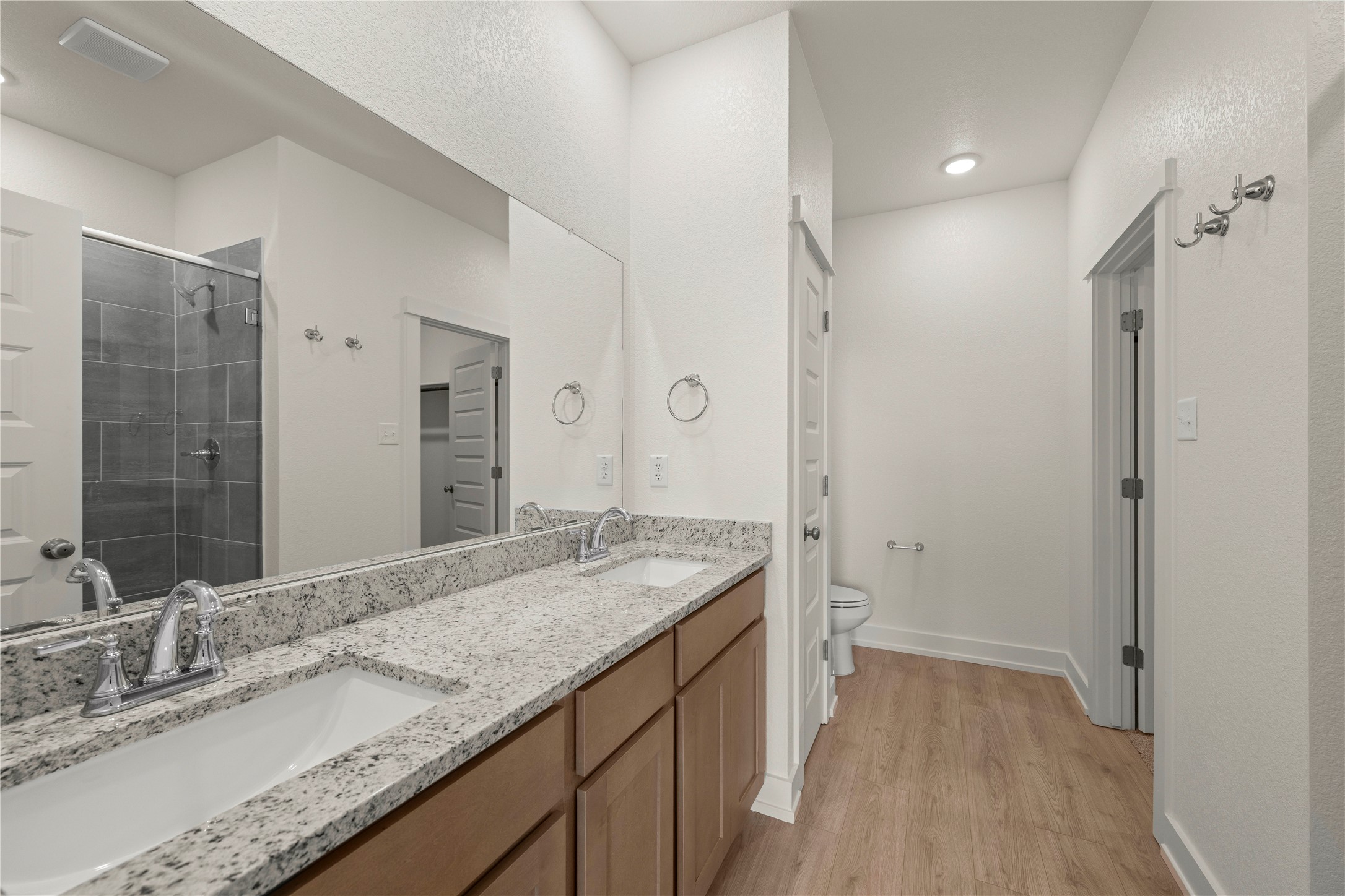 544 Gus Loop Georgetown, TX 78626 - Photo 13 of 22 a bathroom with a granite countertop sink a mirror and a shower
