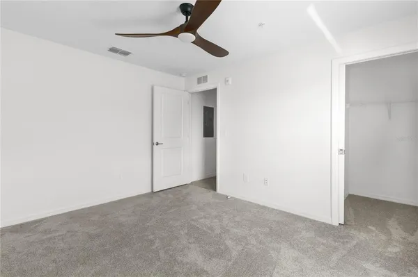 a bathroom with a granite countertop sink a toilet and a mirror