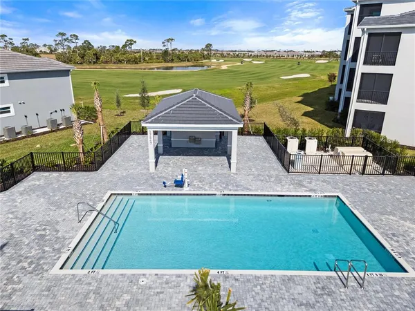 a view of a swimming pool with a yard