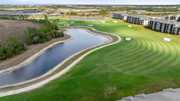 an aerial view of a house a yard and mountain