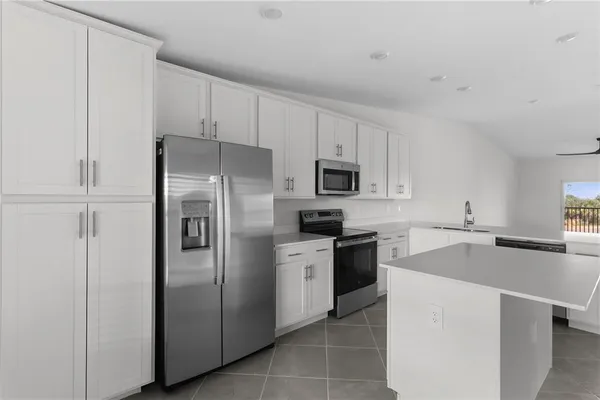 a kitchen with a refrigerator sink and microwave
