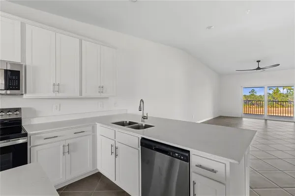 a kitchen with white cabinets and a stove