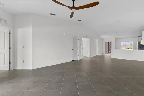 a view of a room with a window and a ceiling fan