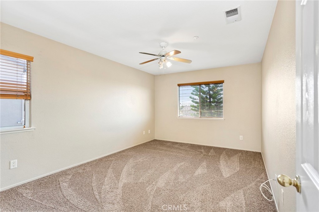 8061 Palm View Lane Riverside, CA 92508 - Photo 13 of 23 an empty room with a window and a ceiling fan
