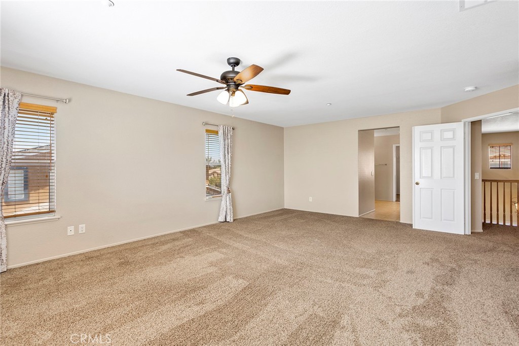 8061 Palm View Lane Riverside, CA 92508 - Photo 17 of 23 a view of a livingroom with a ceiling fan and window