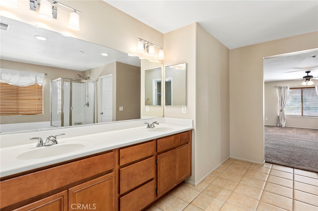 8061 Palm View Lane Riverside, CA 92508 - Photo 18 of 23 a bathroom with a double vanity sink a mirror and a