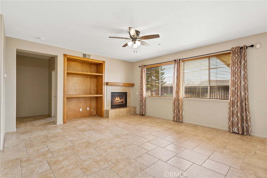 8061 Palm View Lane Riverside, CA 92508 - Photo 6 of 23 an empty room with chandelier fan and windows