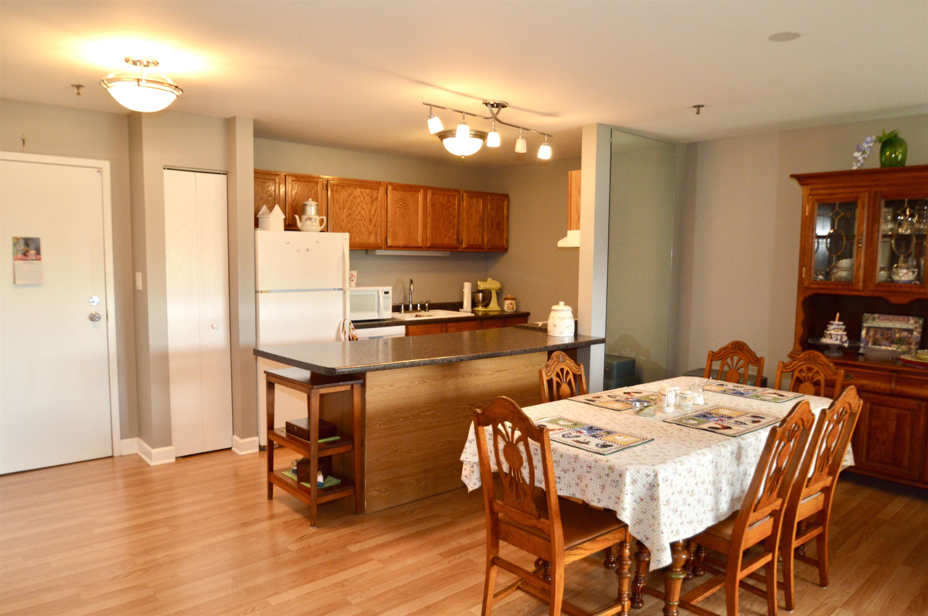 3265 Kirchoff Road Rolling Meadows, IL 60008 - Photo 3 of 14 a kitchen with a table chairs refrigerator and microwave