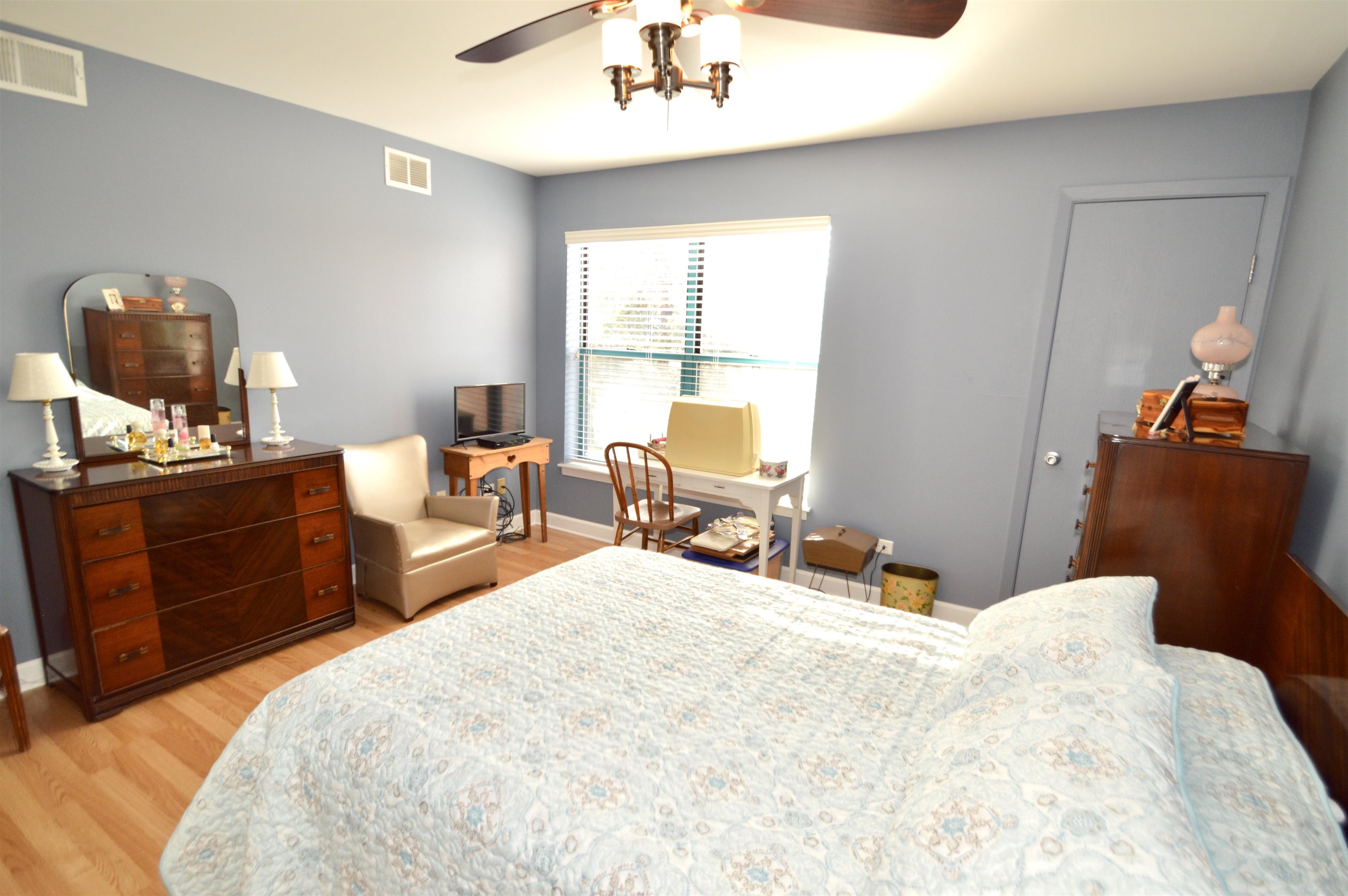 3265 Kirchoff Road Rolling Meadows, IL 60008 - Photo 9 of 14 a bedroom with a bed and a chandelier