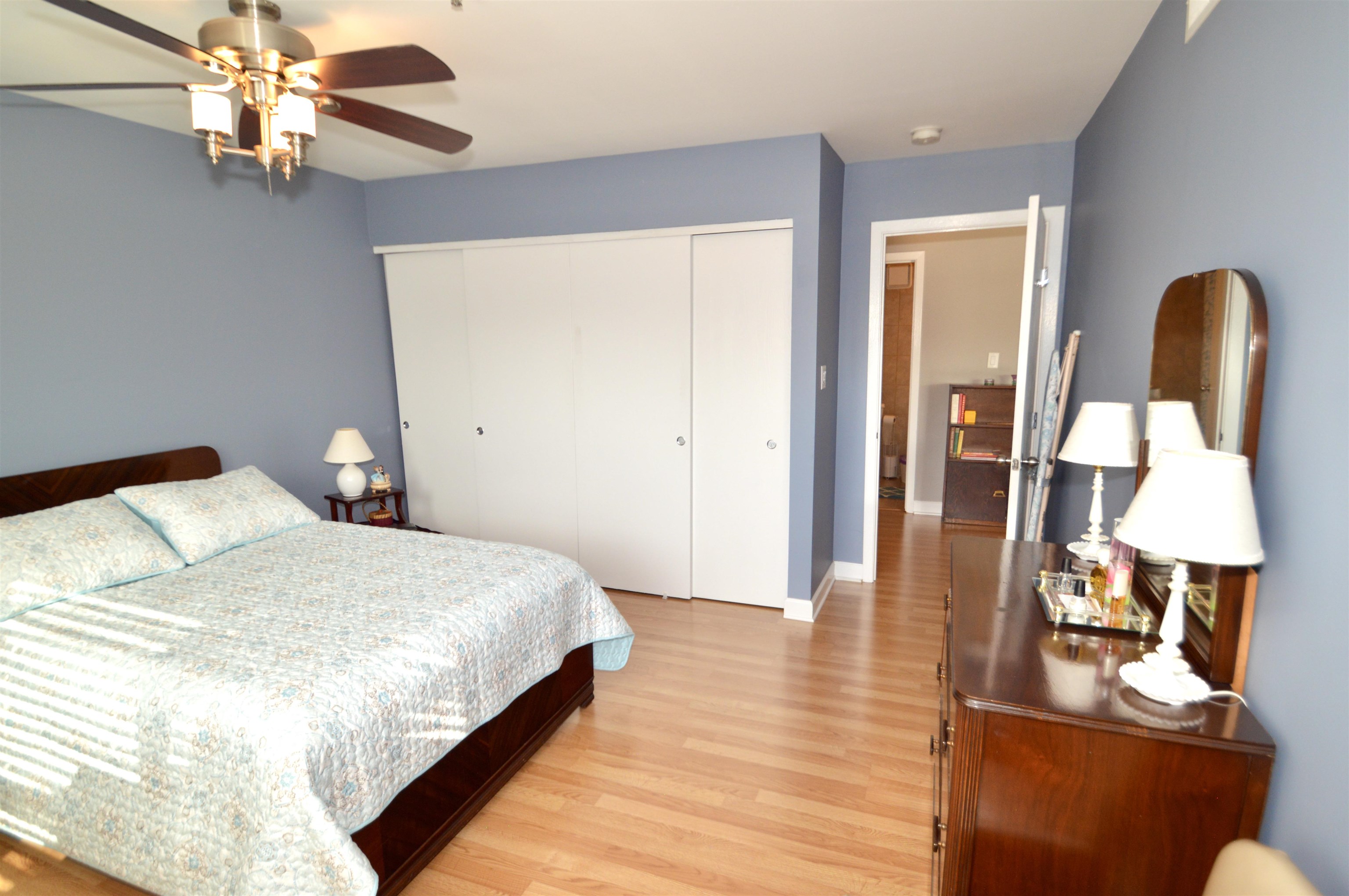 3265 Kirchoff Road Rolling Meadows, IL 60008 - Photo 10 of 14 a bedroom with a bed and wooden floor