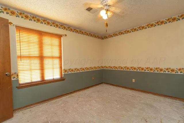 a view of a room with windows and ceiling fan