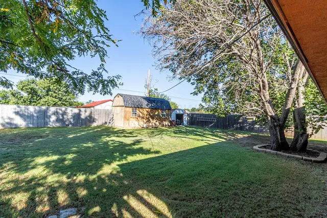 a swimming pool with outdoor seating and yard