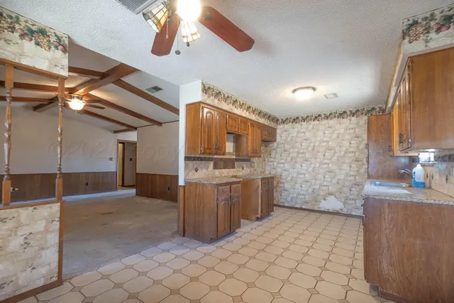 a kitchen with a sink and cabinets