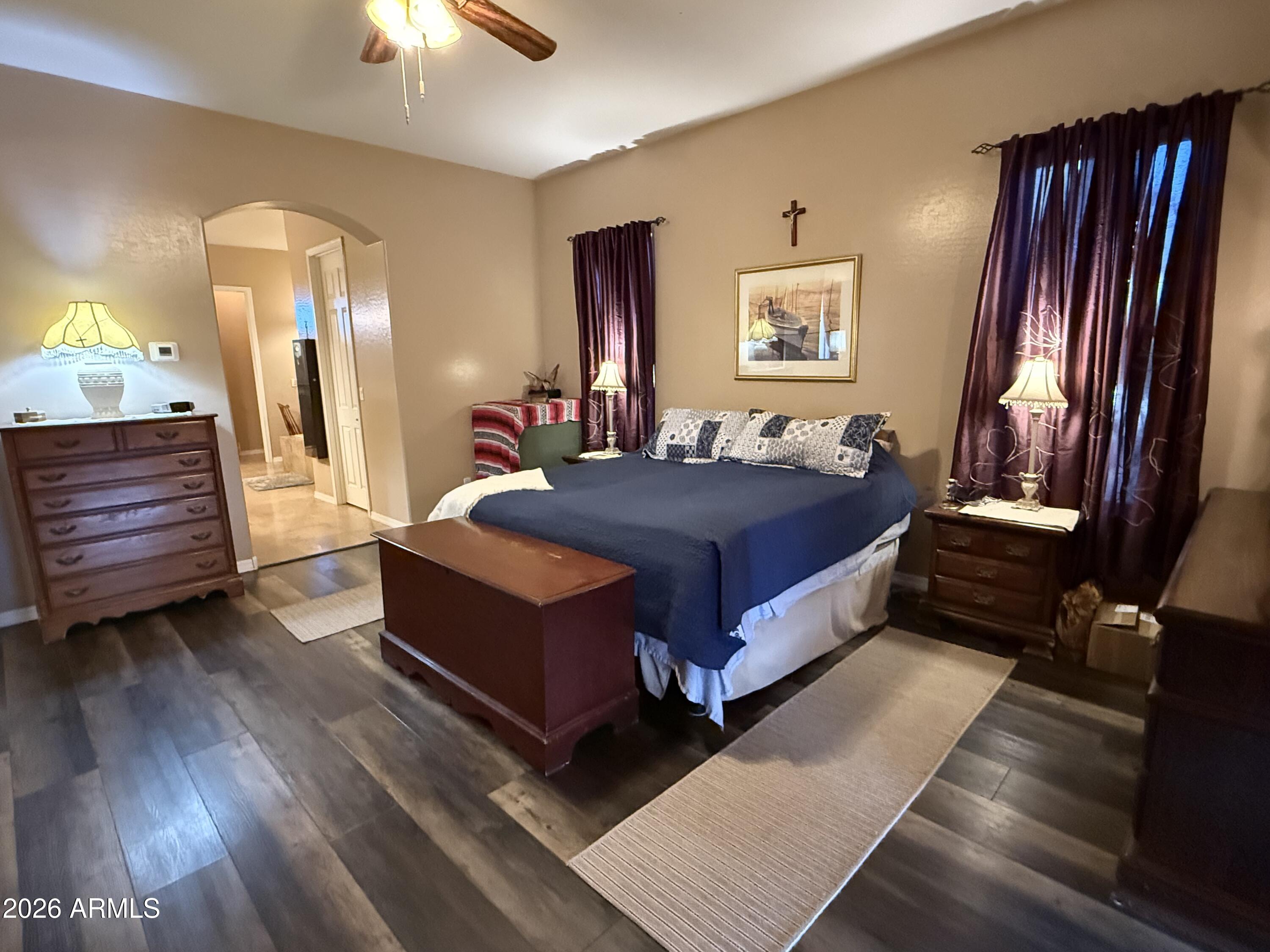 2569 West Silverdale Road San Tan Valley, AZ 85144 - Photo 13 of 61 a large bedroom with a bed and wooden floor