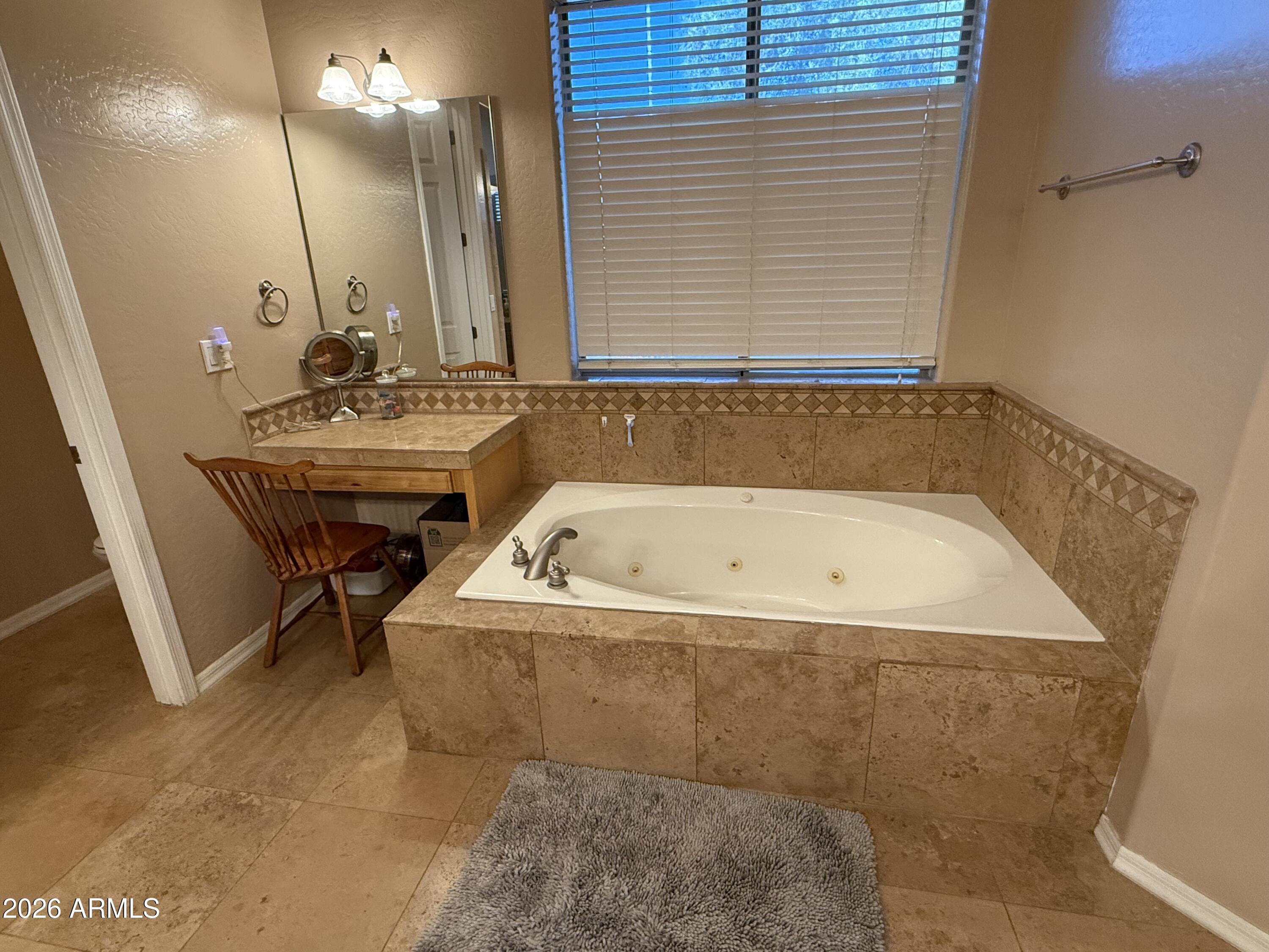 2569 West Silverdale Road San Tan Valley, AZ 85144 - Photo 16 of 61 a bathroom with a tub a sink and a mirror