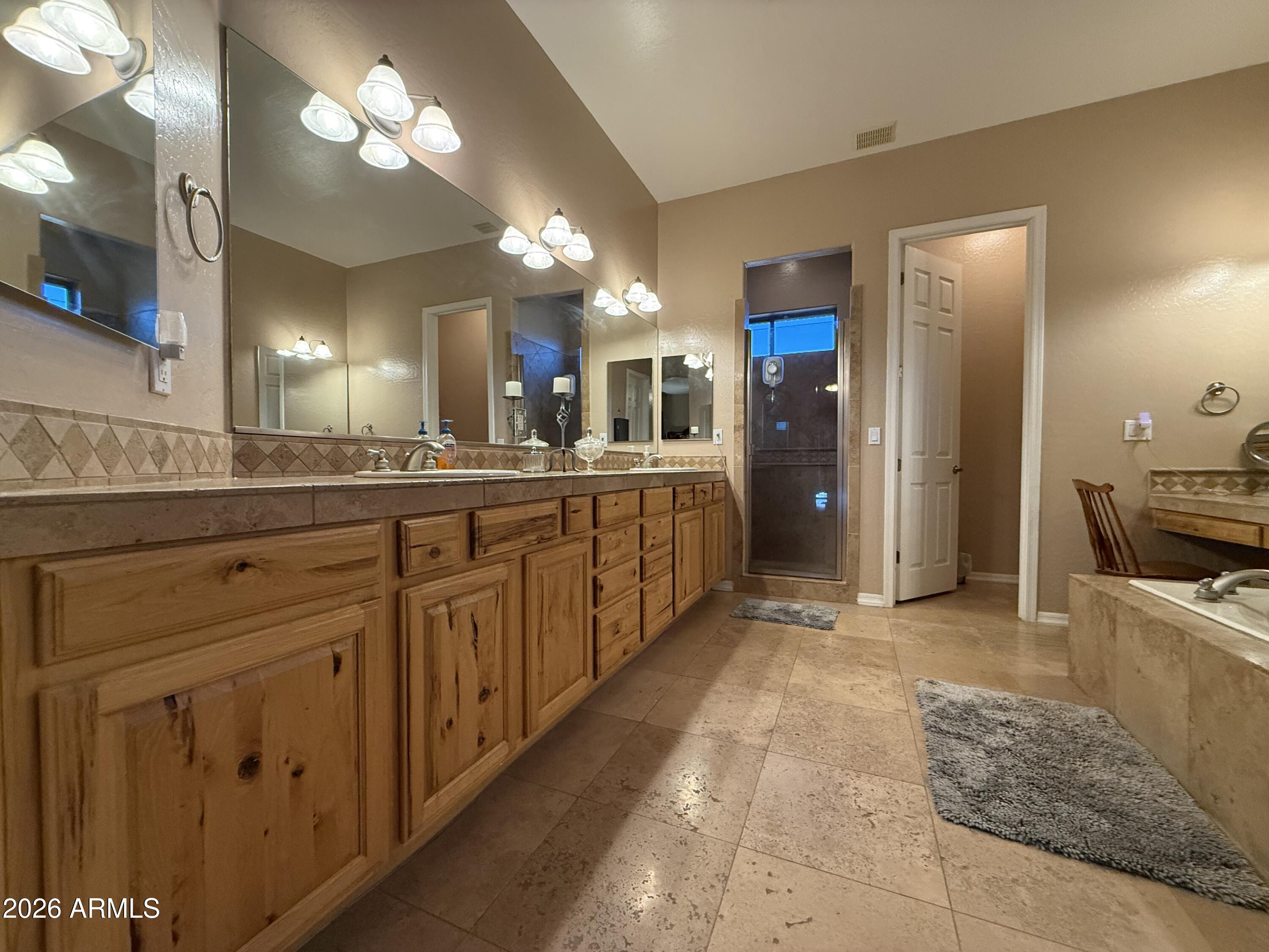 2569 West Silverdale Road San Tan Valley, AZ 85144 - Photo 19 of 61 a large bathroom with a large mirror vanity and sink
