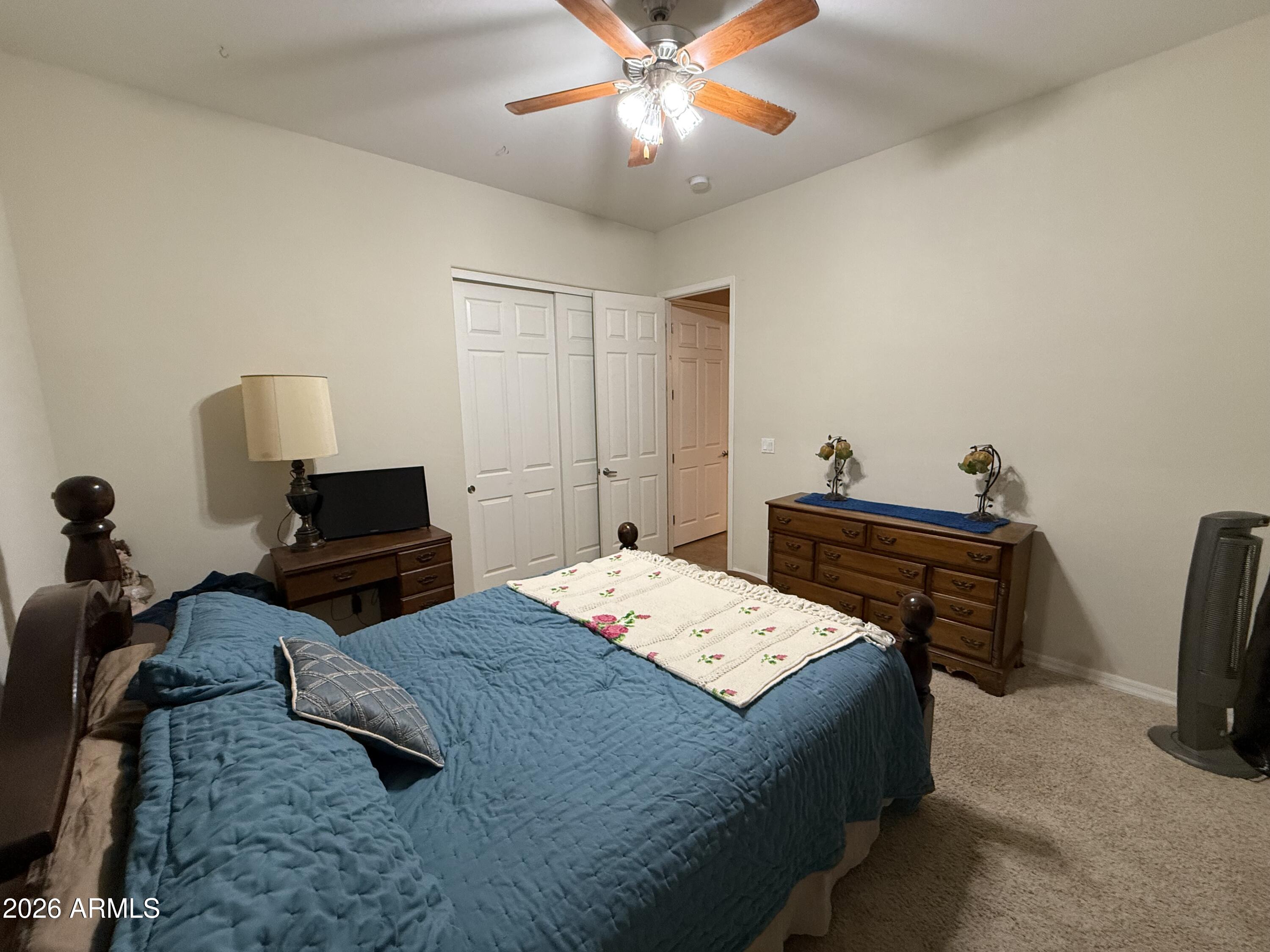 2569 West Silverdale Road San Tan Valley, AZ 85144 - Photo 22 of 61 a bedroom with a bed and a chandelier