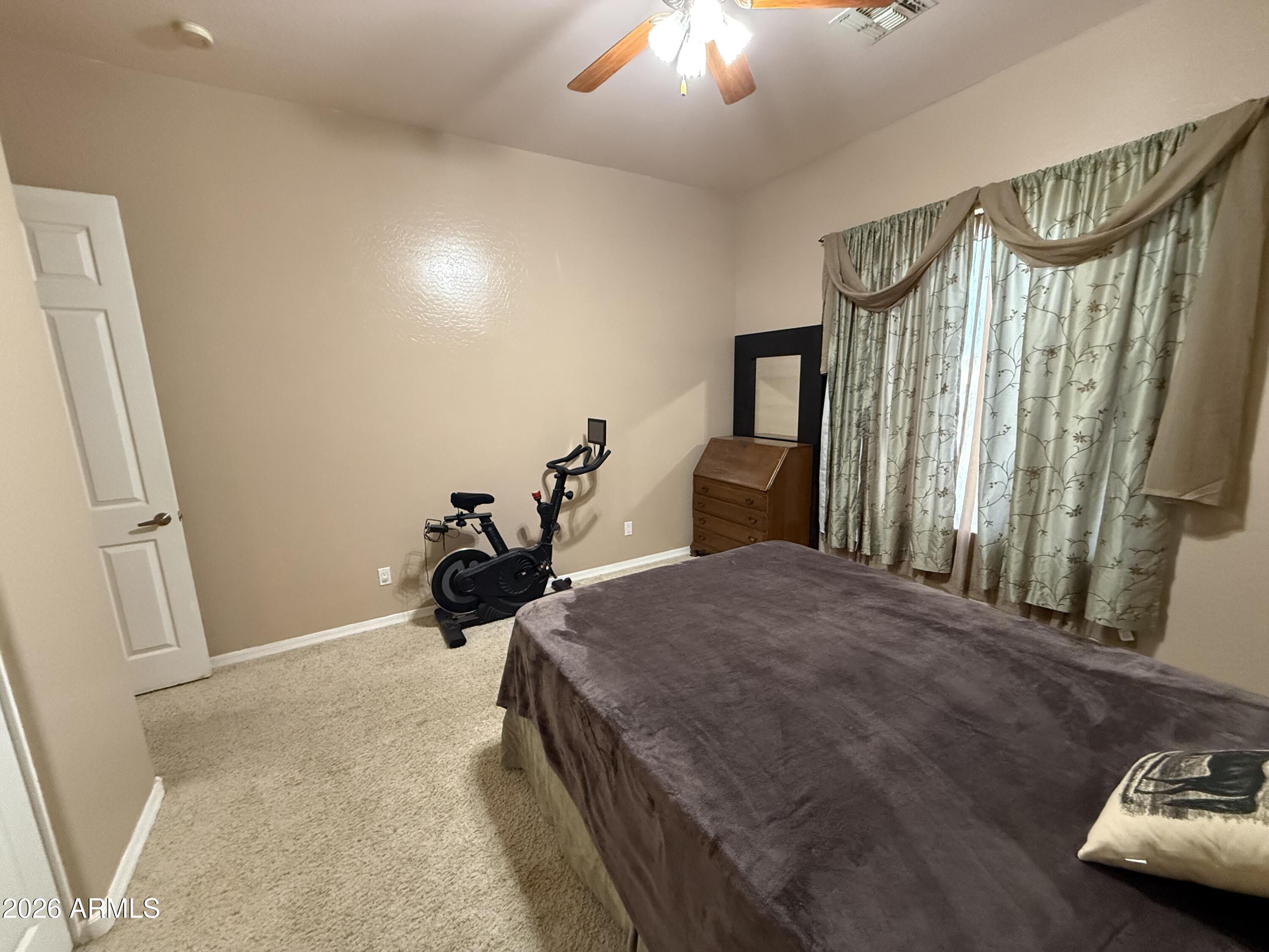 2569 West Silverdale Road San Tan Valley, AZ 85144 - Photo 23 of 61 a bed room with a bed and a television