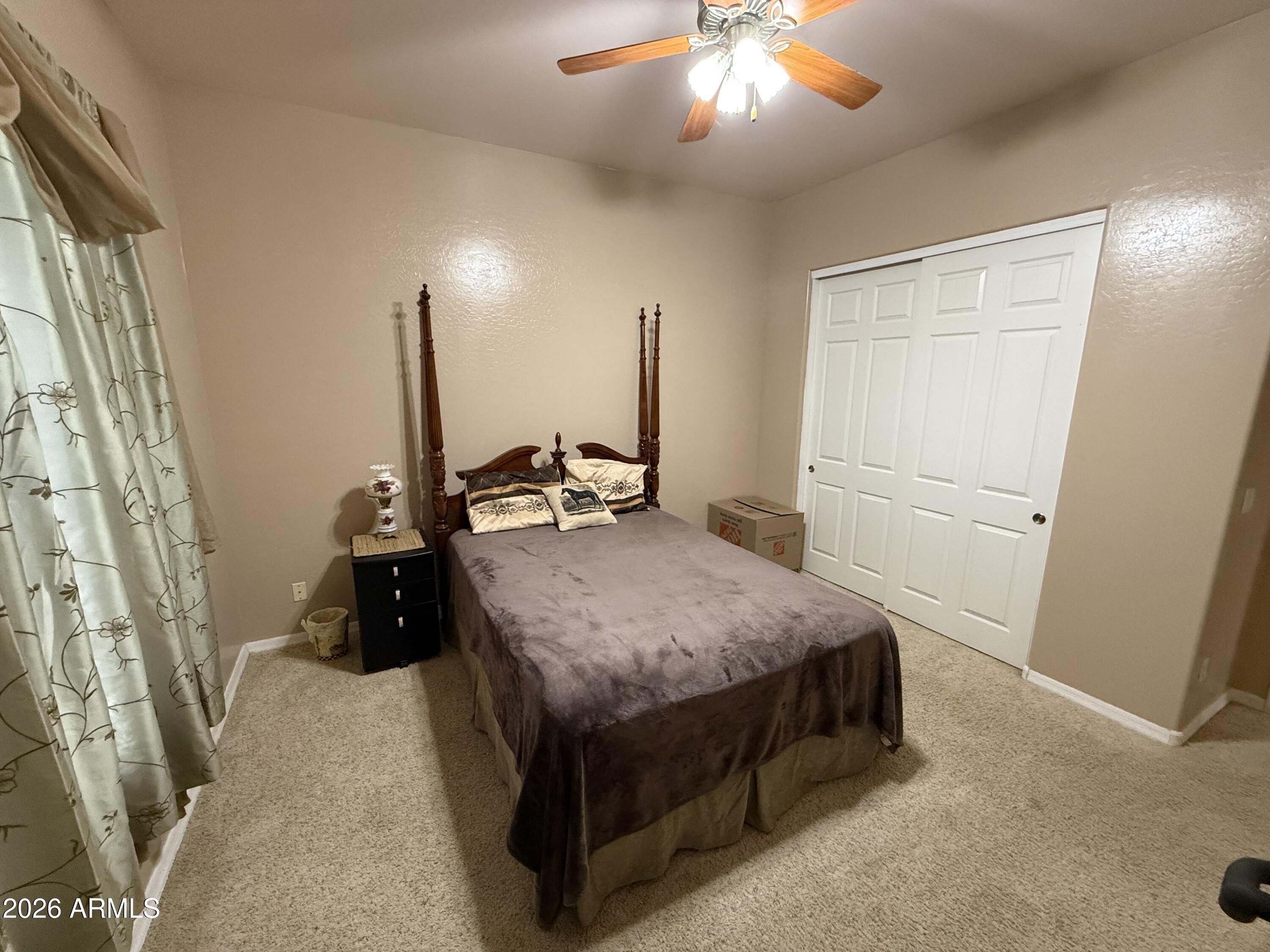 2569 West Silverdale Road San Tan Valley, AZ 85144 - Photo 24 of 61 a bed room with a bed and a walk in closet