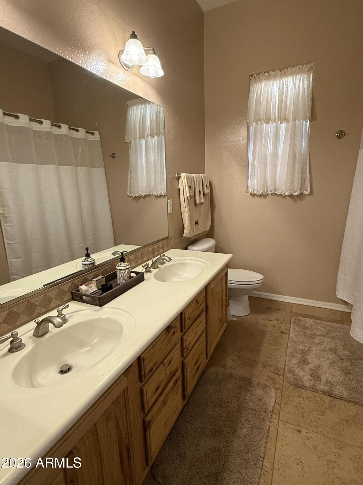 2569 West Silverdale Road San Tan Valley, AZ 85144 - Photo 25 of 61 a bathroom with a sink and a mirror