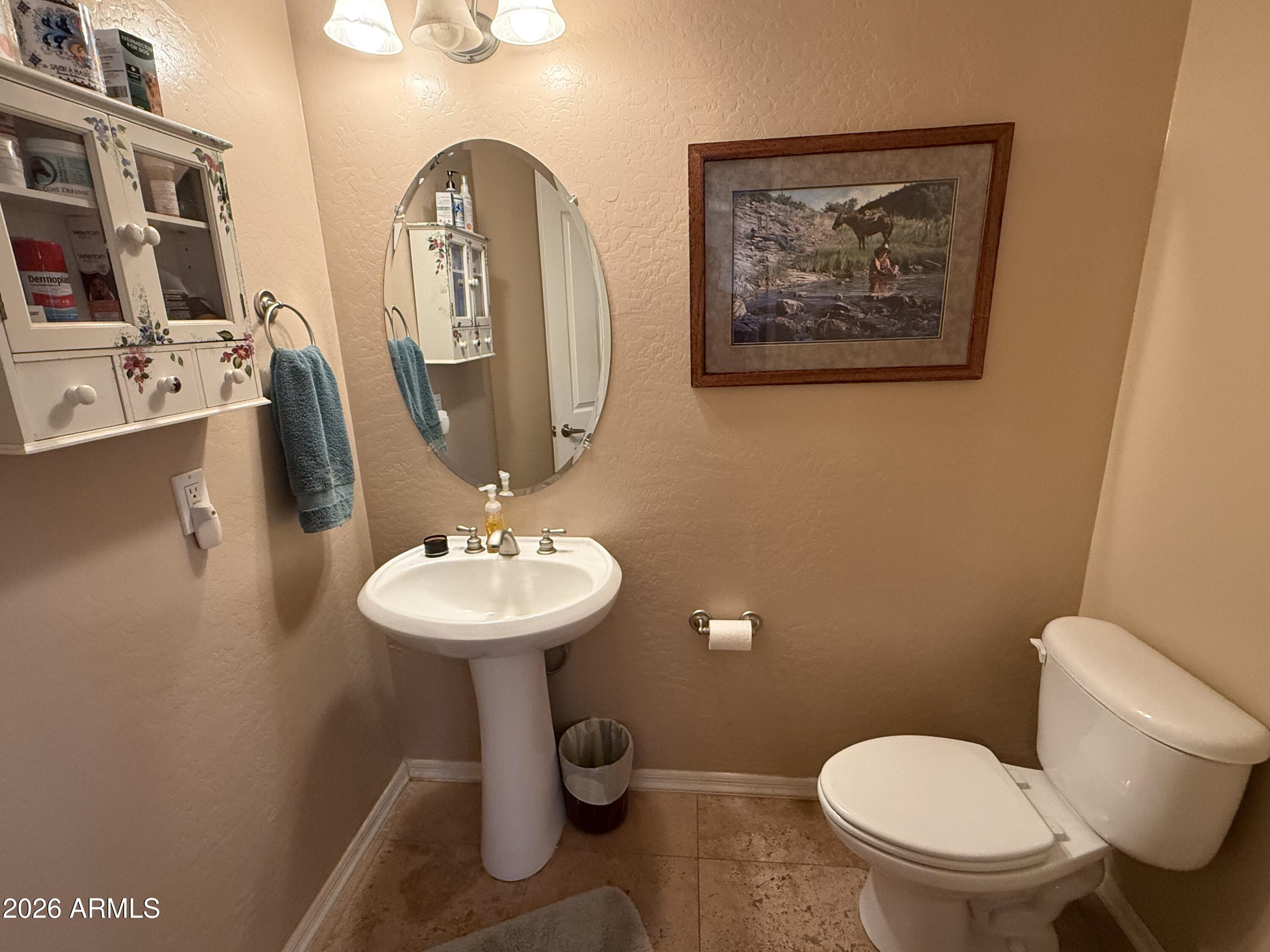 2569 West Silverdale Road San Tan Valley, AZ 85144 - Photo 26 of 61 a bathroom with a toilet sink and mirror