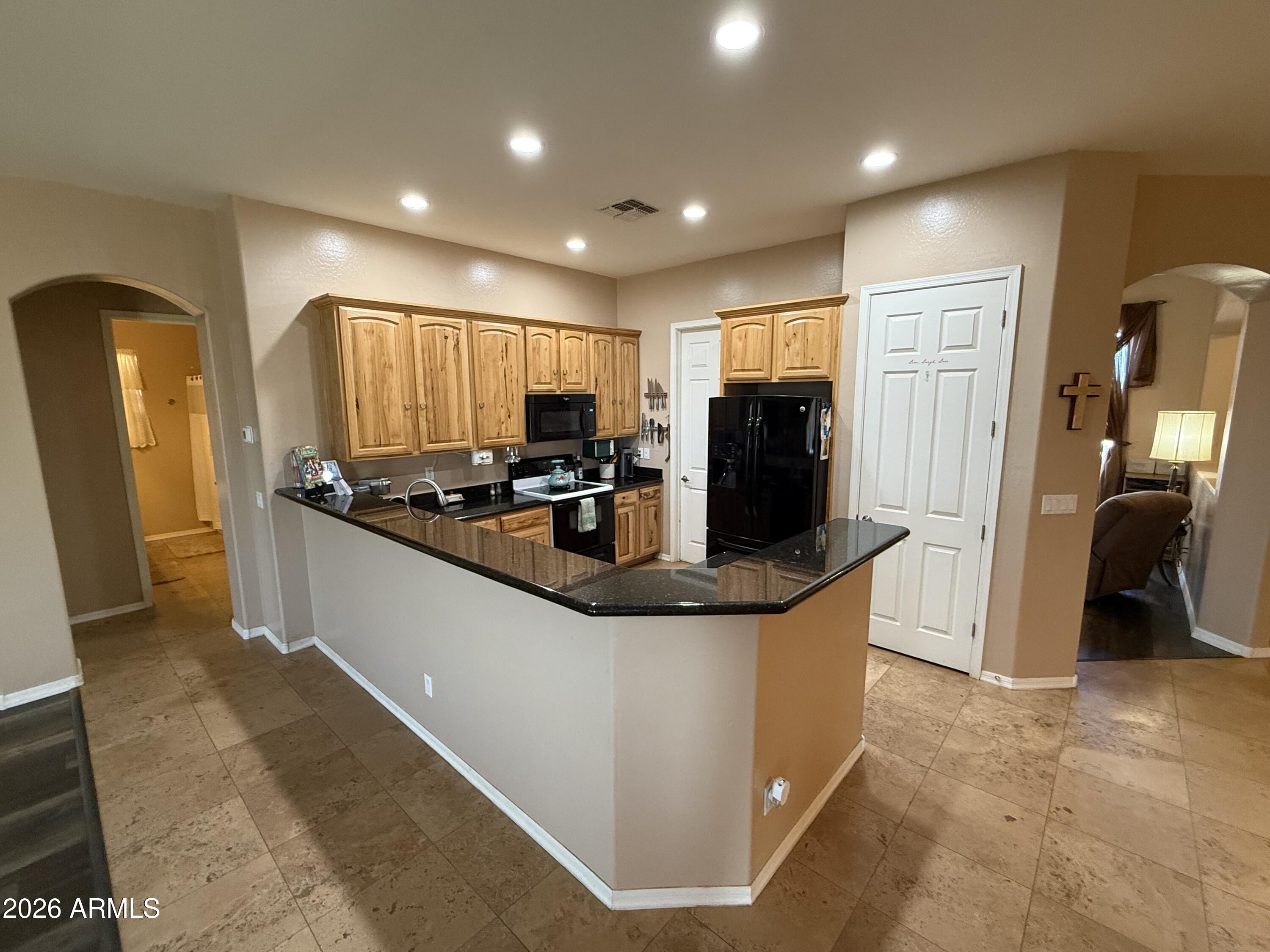 2569 West Silverdale Road San Tan Valley, AZ 85144 - Photo 3 of 61 a kitchen with stainless steel appliances granite countertop a stove and a refrigerator