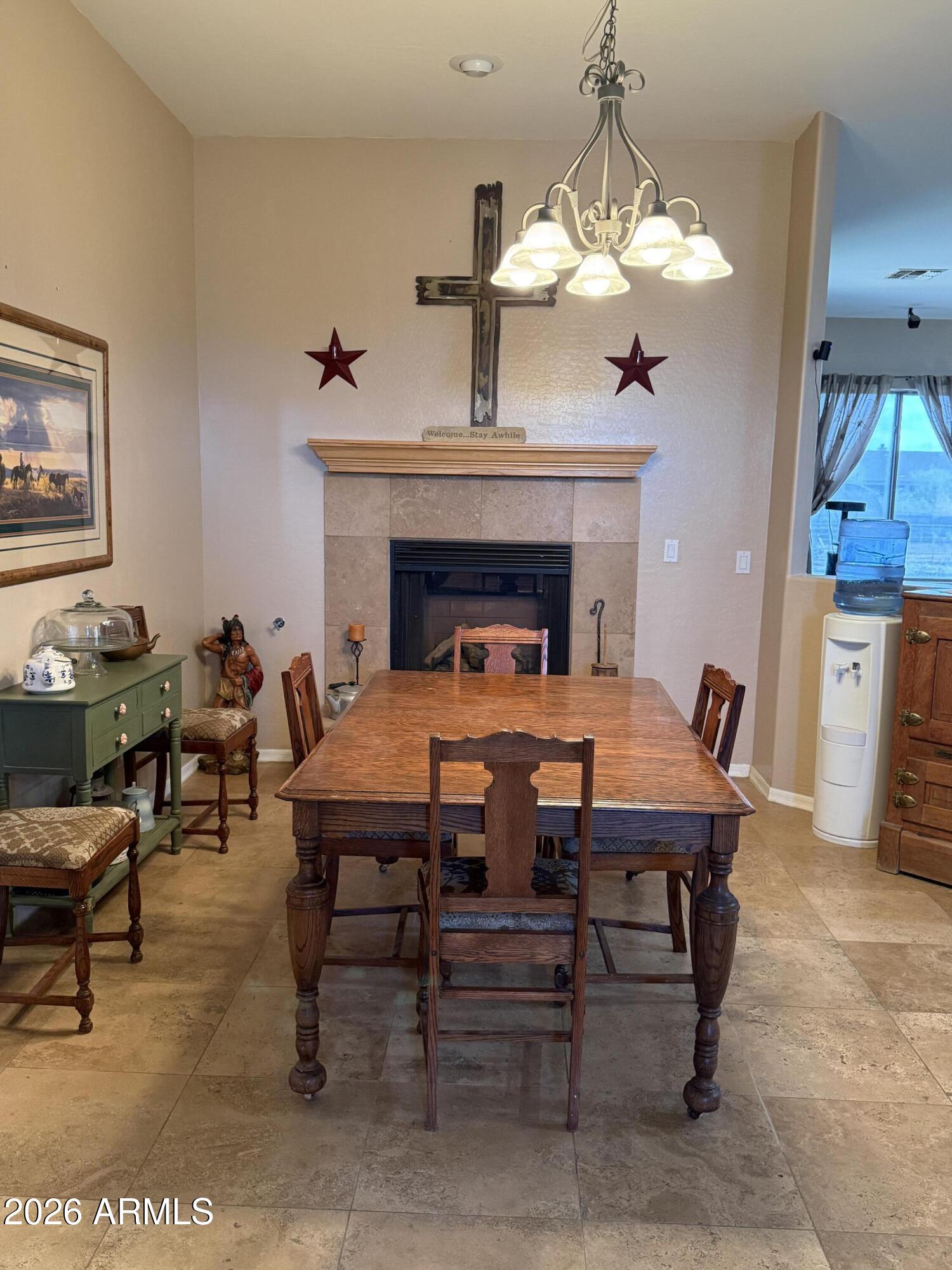 2569 West Silverdale Road San Tan Valley, AZ 85144 - Photo 34 of 61 a dining room with a table and chairs