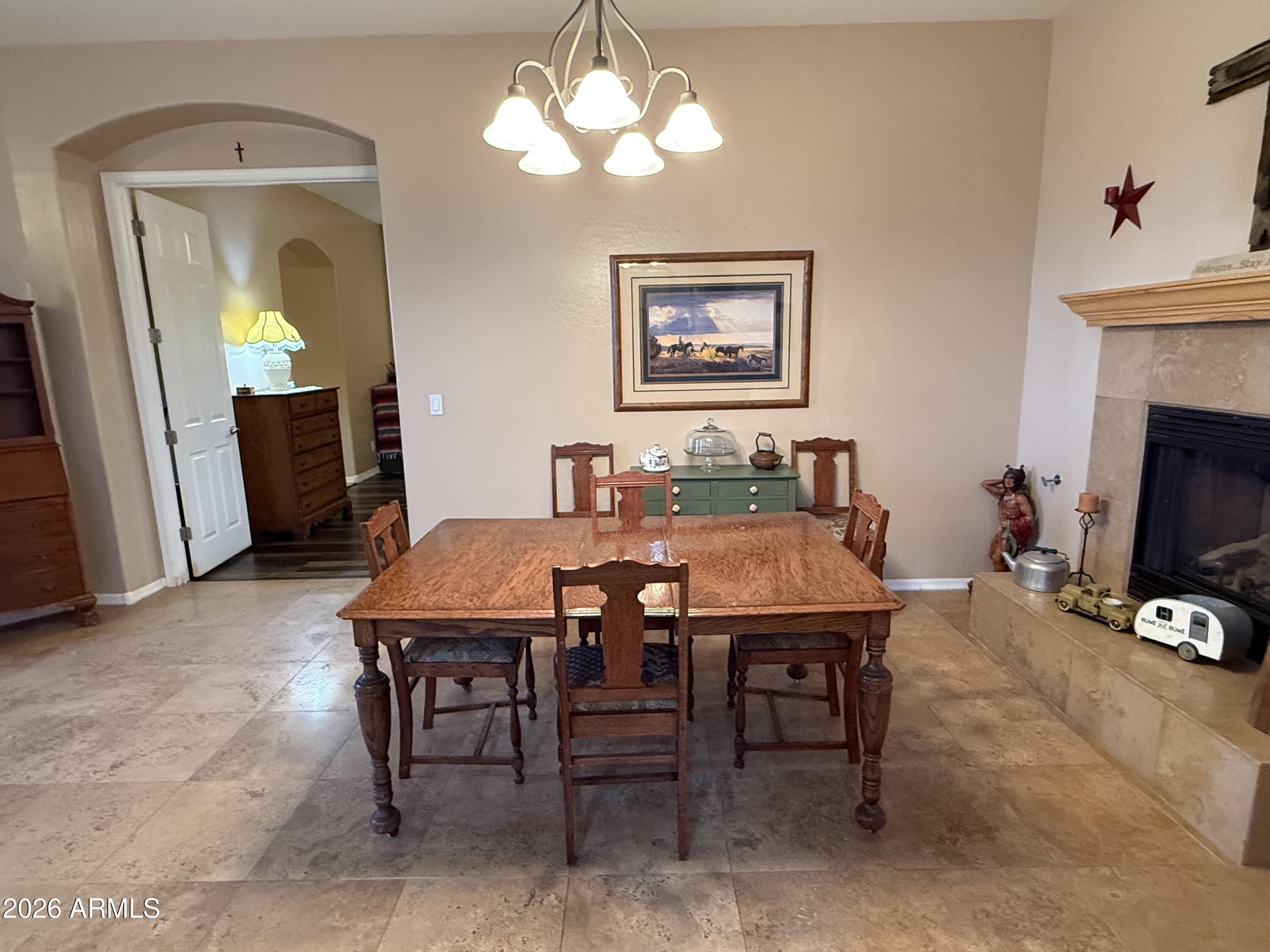 2569 West Silverdale Road San Tan Valley, AZ 85144 - Photo 35 of 61 a view of a dining room with furniture and a chandelier