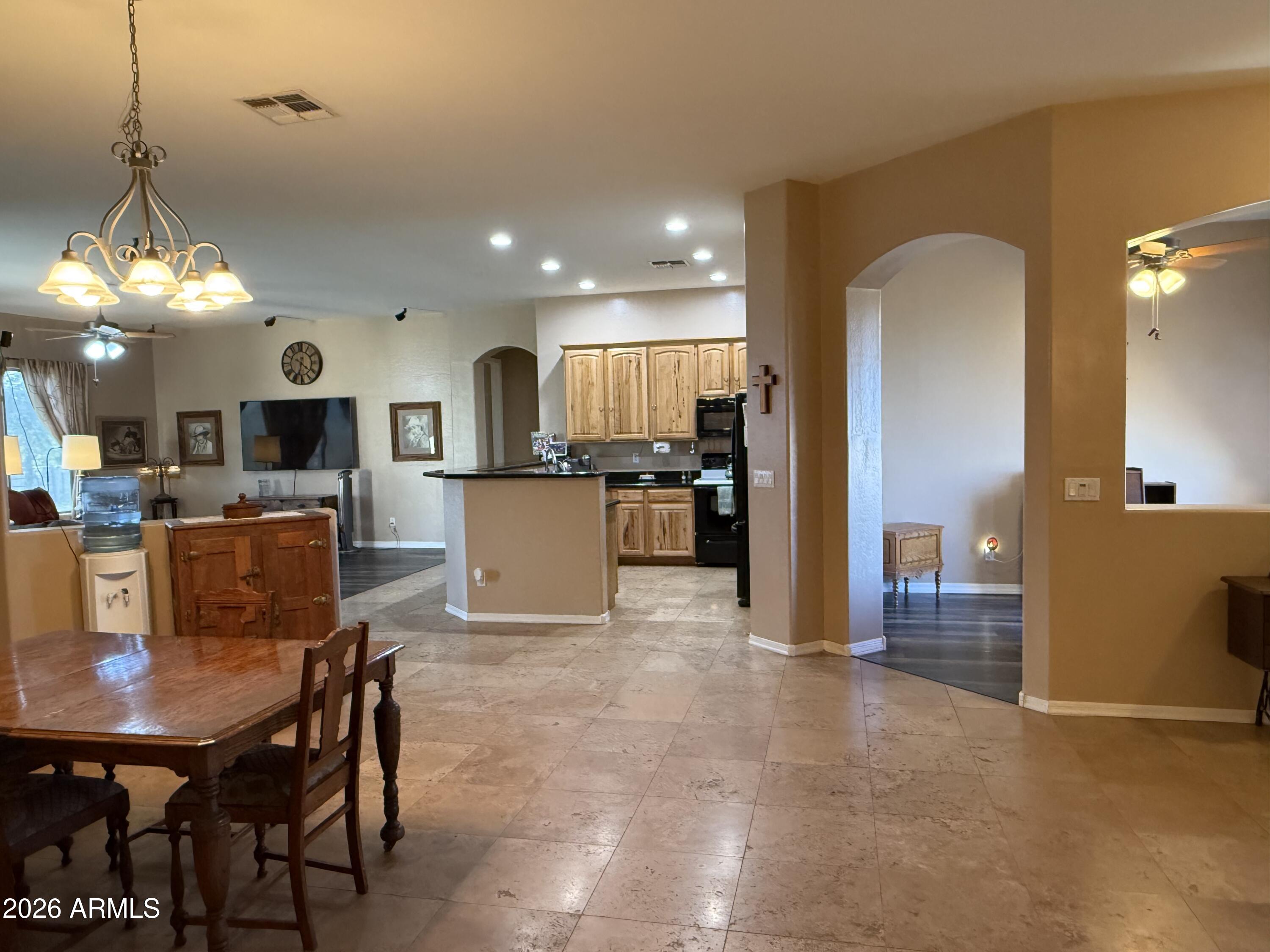 2569 West Silverdale Road San Tan Valley, AZ 85144 - Photo 5 of 61 a view of a dining room with furniture and wooden floor