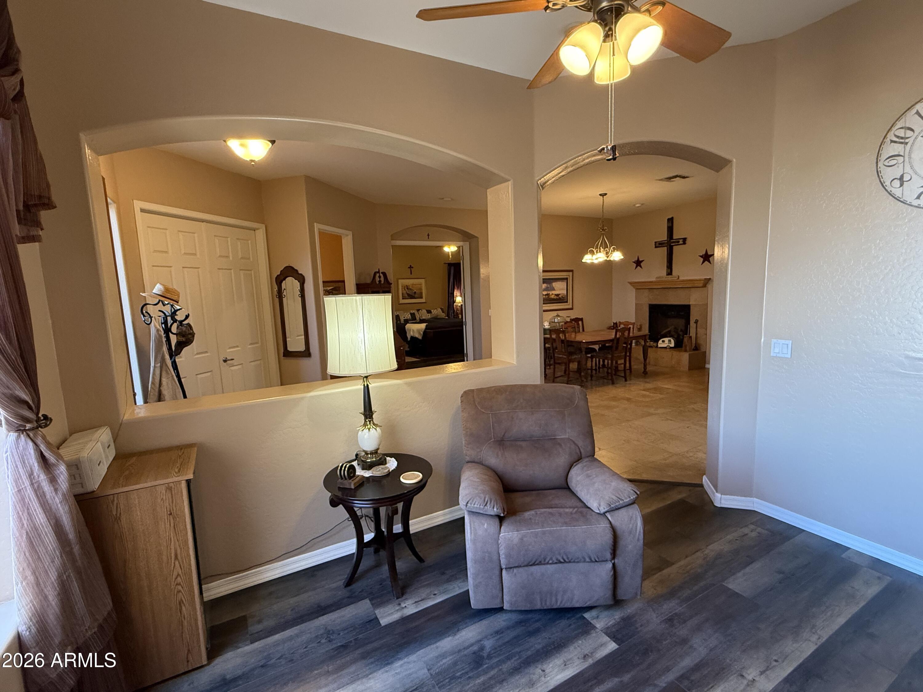 2569 West Silverdale Road San Tan Valley, AZ 85144 - Photo 8 of 61 a living room with furniture and a chandelier