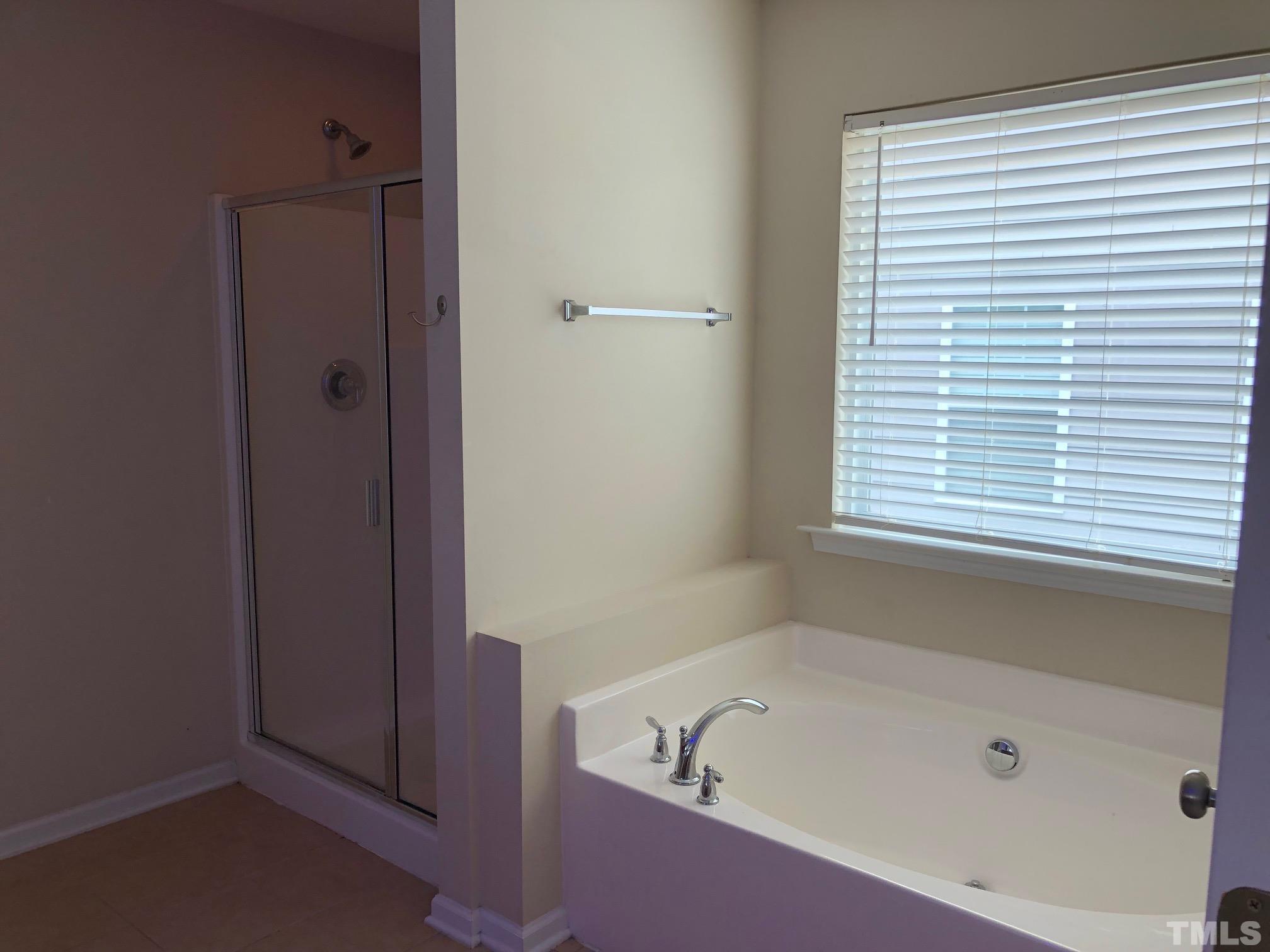 4252 Brintons Cottage Street Raleigh, NC 27616 - Photo 13 of 19 a bathroom with a bathtub