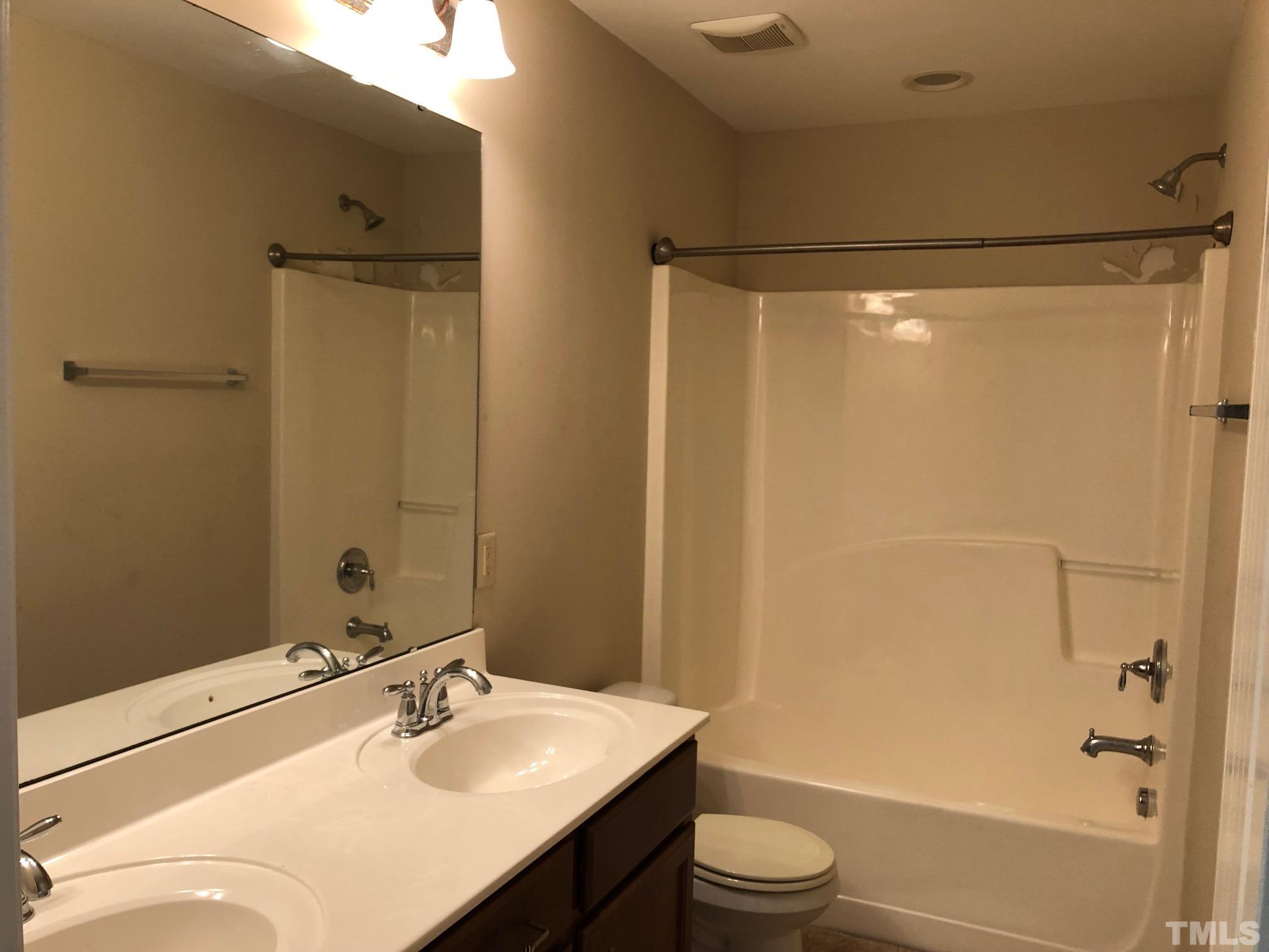 4252 Brintons Cottage Street Raleigh, NC 27616 - Photo 16 of 19 a bathroom with a sink toilet and shower