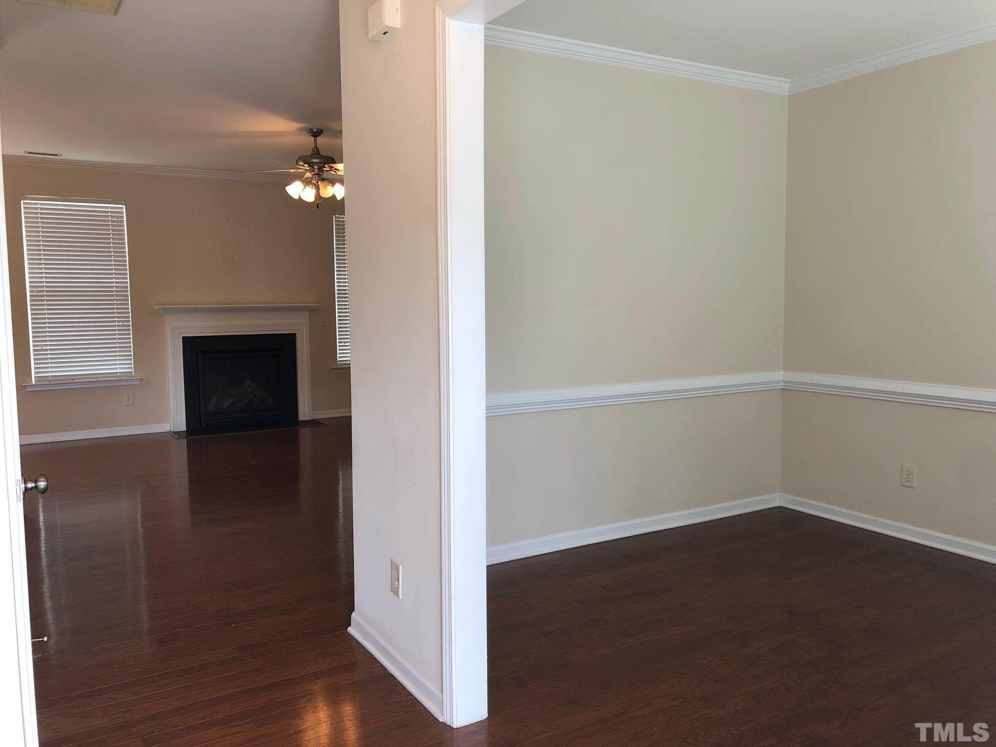 4252 Brintons Cottage Street Raleigh, NC 27616 - Photo 2 of 19 an empty room with wooden floor cabinet and windows