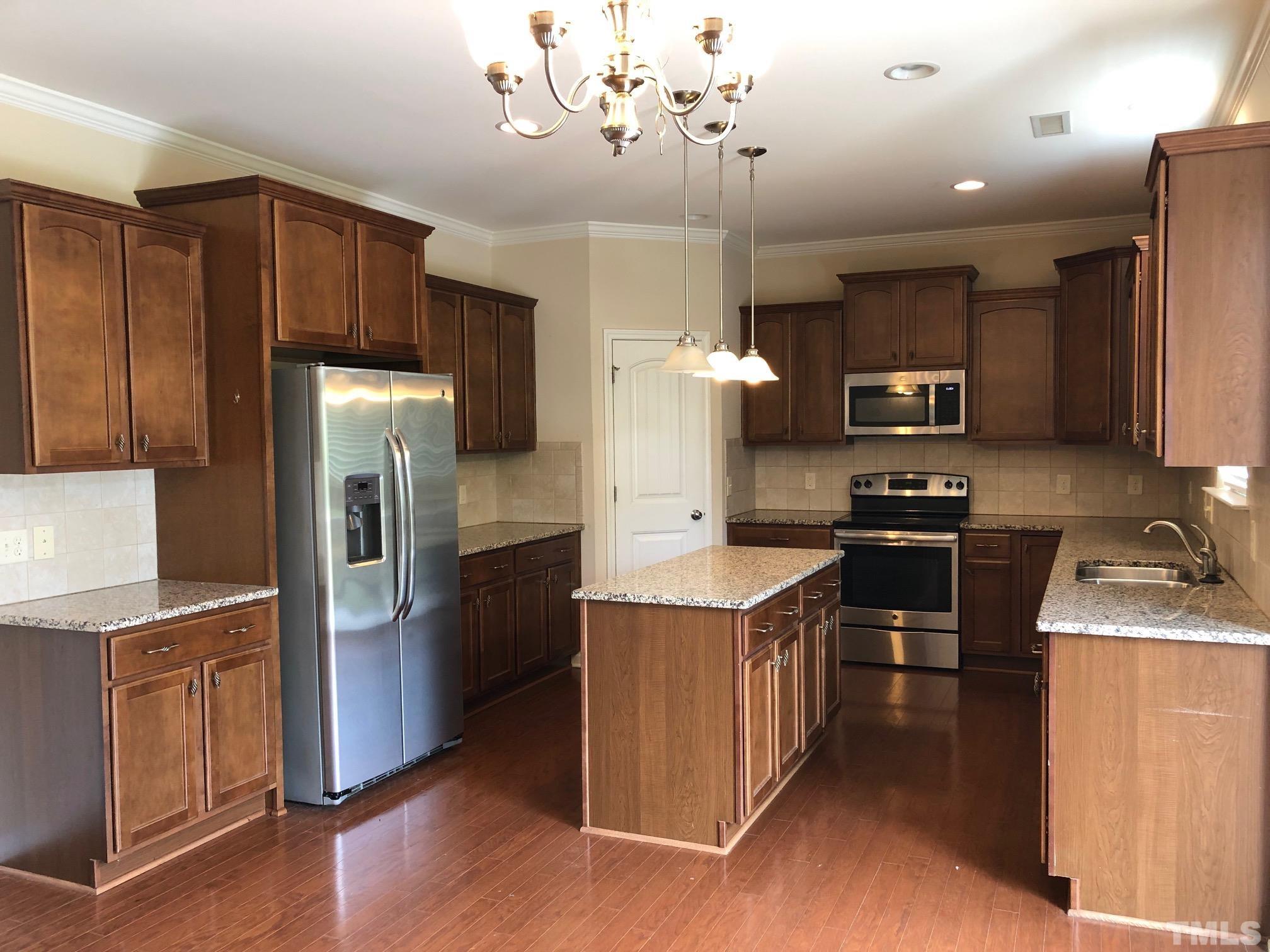 4252 Brintons Cottage Street Raleigh, NC 27616 - Photo 6 of 19 a kitchen with stainless steel appliances granite countertop a refrigerator stove and sink