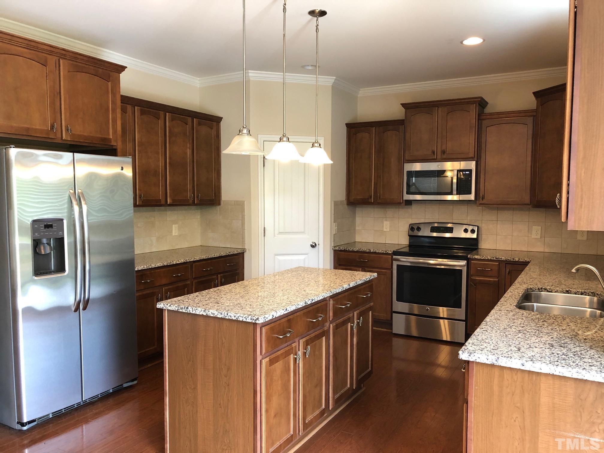 4252 Brintons Cottage Street Raleigh, NC 27616 - Photo 7 of 19 a kitchen with stainless steel appliances granite countertop a refrigerator stove microwave and sink