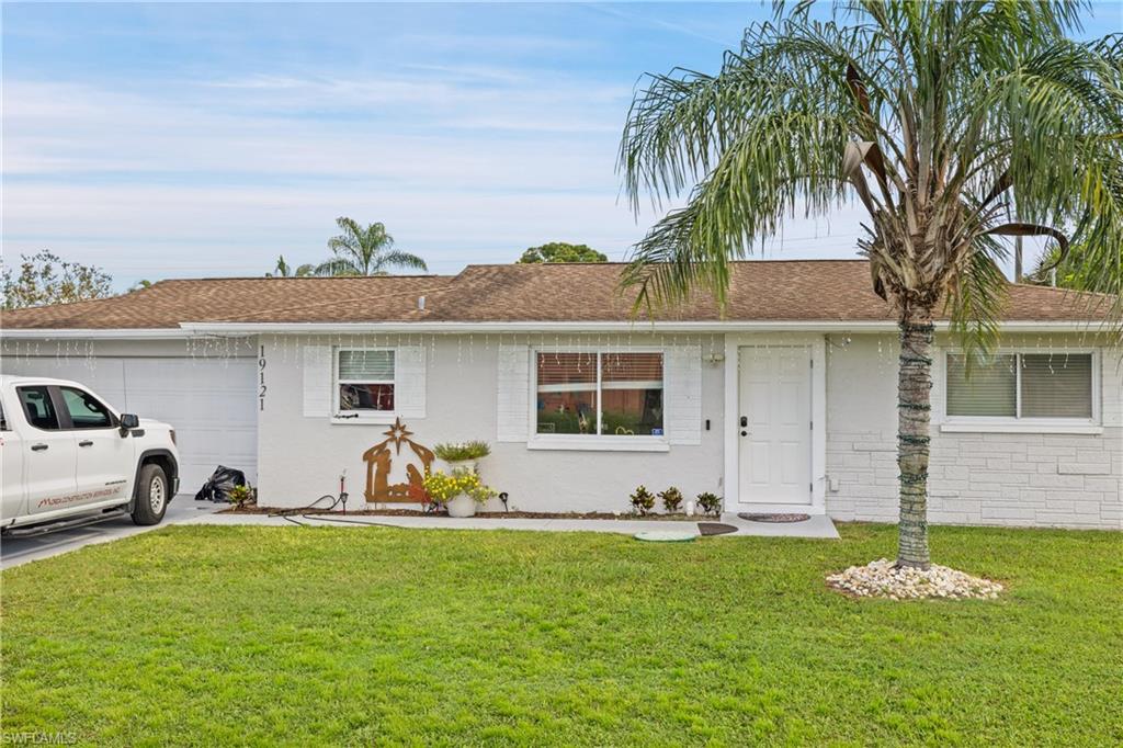 19121 Acorn Road Fort Myers, FL 33967 - Photo 5 of 23 Ranch-style home featuring a garage and a front lawn
