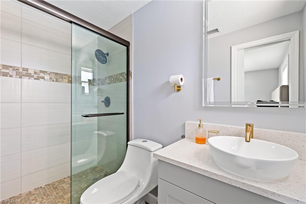 19121 Acorn Road Fort Myers, FL 33967 - Photo 8 of 23 Bathroom with toilet, an enclosed shower, and vanity