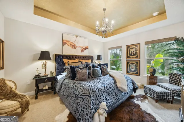 a bedroom with a bed and a chandelier