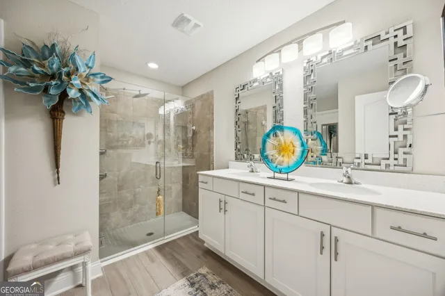a bathroom with a shower sink and mirror