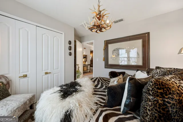 a bedroom with bed and a chandelier
