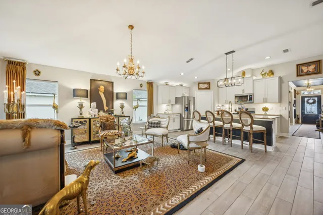 a living room with lots of furniture and a chandelier