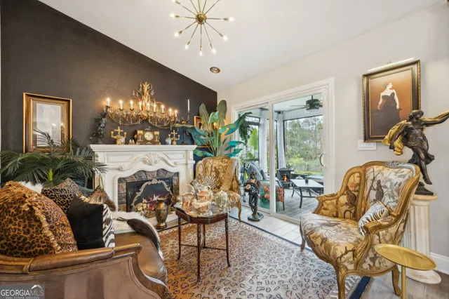 a living room with furniture a chandelier and a flat screen tv