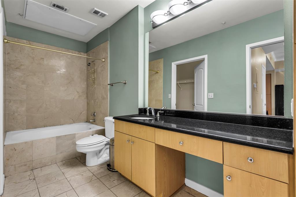 3225 Turtle Creek Boulevard, Unit 10 Dallas, TX 75219 - Photo 11 of 38 Full bathroom with vanity, tiled shower / bath, and a spacious closet