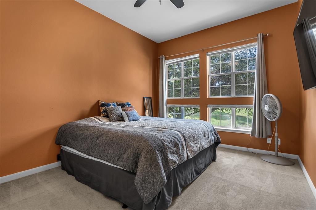 3225 Turtle Creek Boulevard, Unit 10 Dallas, TX 75219 - Photo 12 of 38 Bedroom featuring light colored carpet and a ceiling fan
