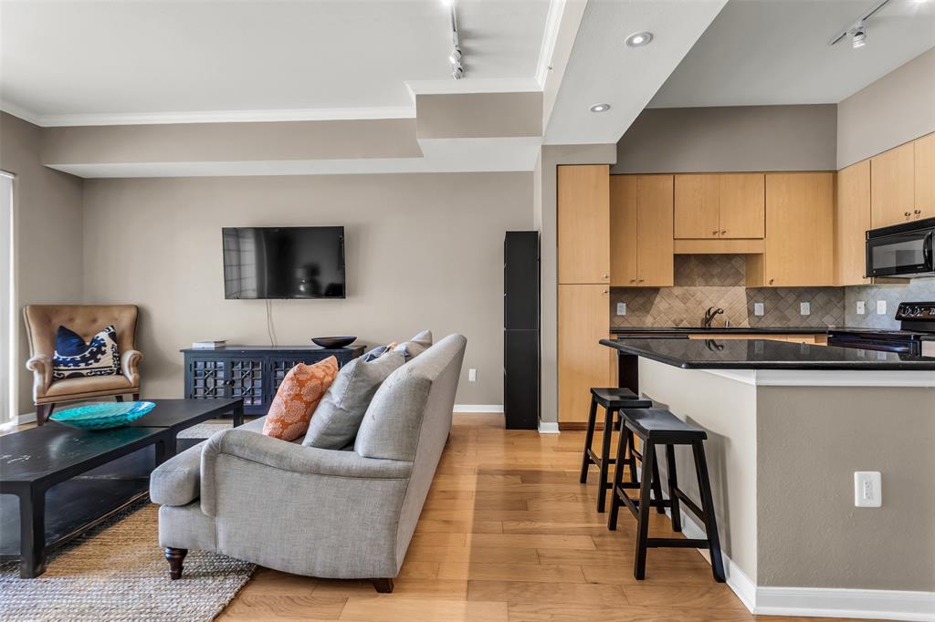 3225 Turtle Creek Boulevard, Unit 10 Dallas, TX 75219 - Photo 17 of 38 Living area with rail lighting, light wood-style floors, and crown molding