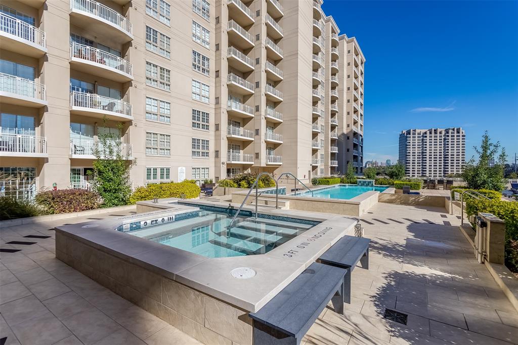 3225 Turtle Creek Boulevard, Unit 10 Dallas, TX 75219 - Photo 21 of 38 Community pool with a hot tub and a patio area