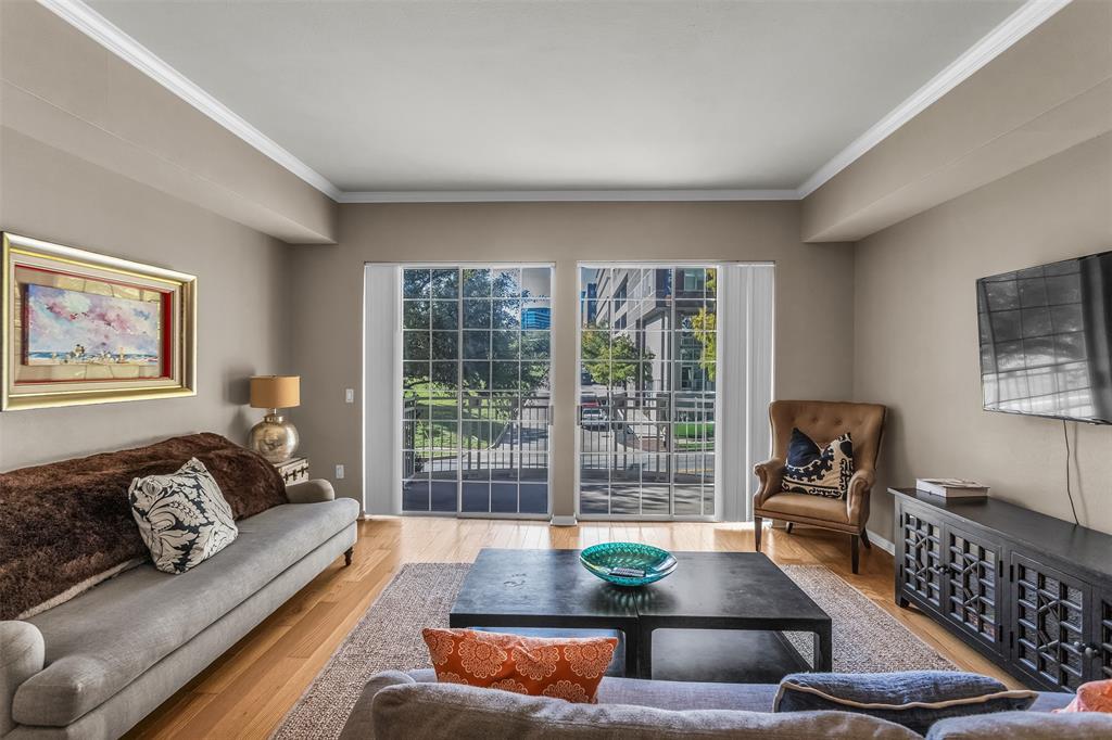 3225 Turtle Creek Boulevard, Unit 10 Dallas, TX 75219 - Photo 6 of 38 Living room featuring crown molding and wood finished floors