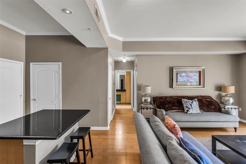 3225 Turtle Creek Boulevard, Unit 10 Dallas, TX 75219 - Photo 8 of 38 Living room featuring light wood-type flooring and ornamental molding